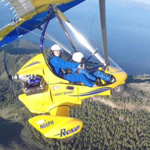 Student learning to control the powered hang glider above Lake Tahoe.